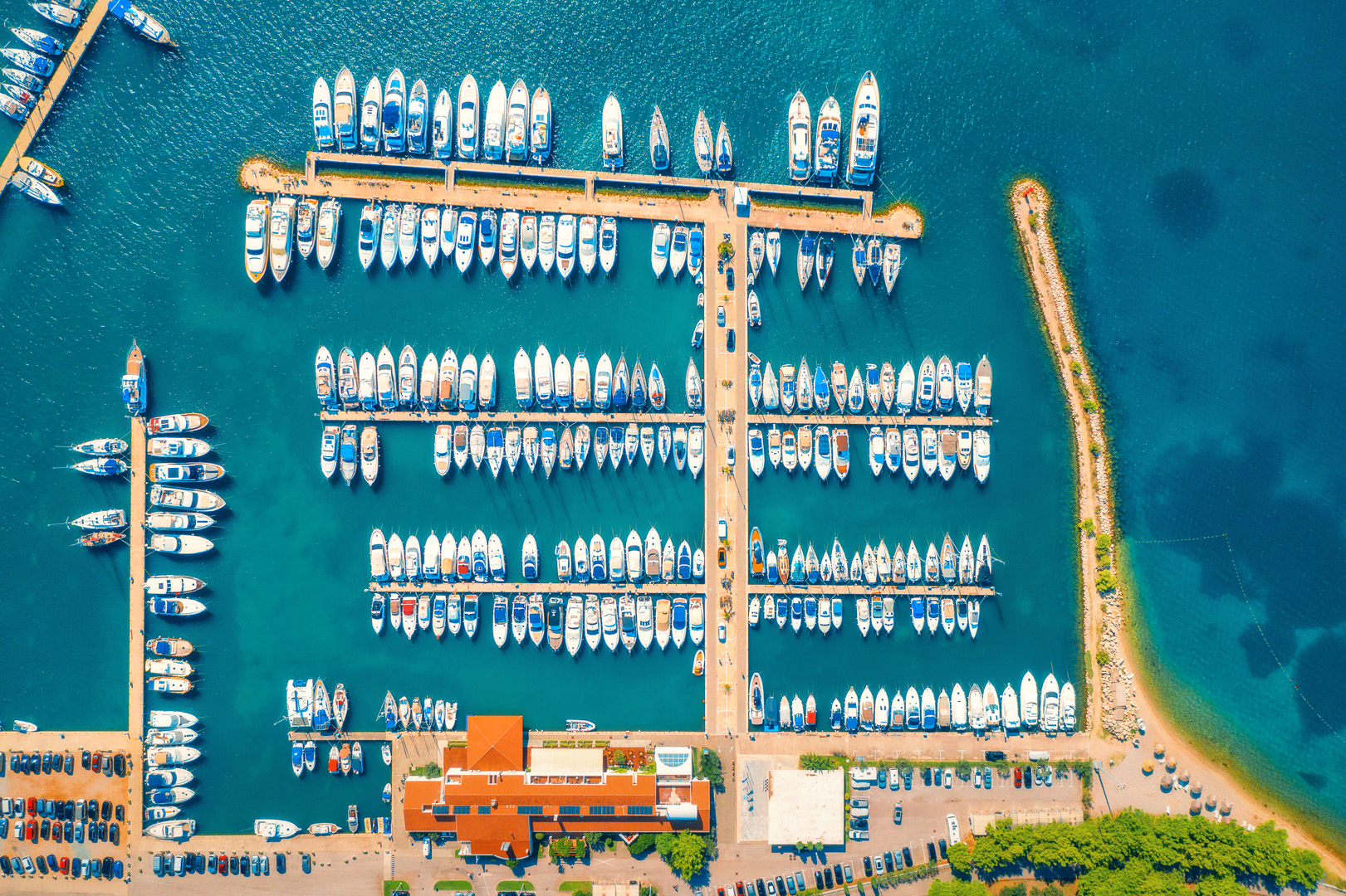 Yachts moored at a marina at golden hour